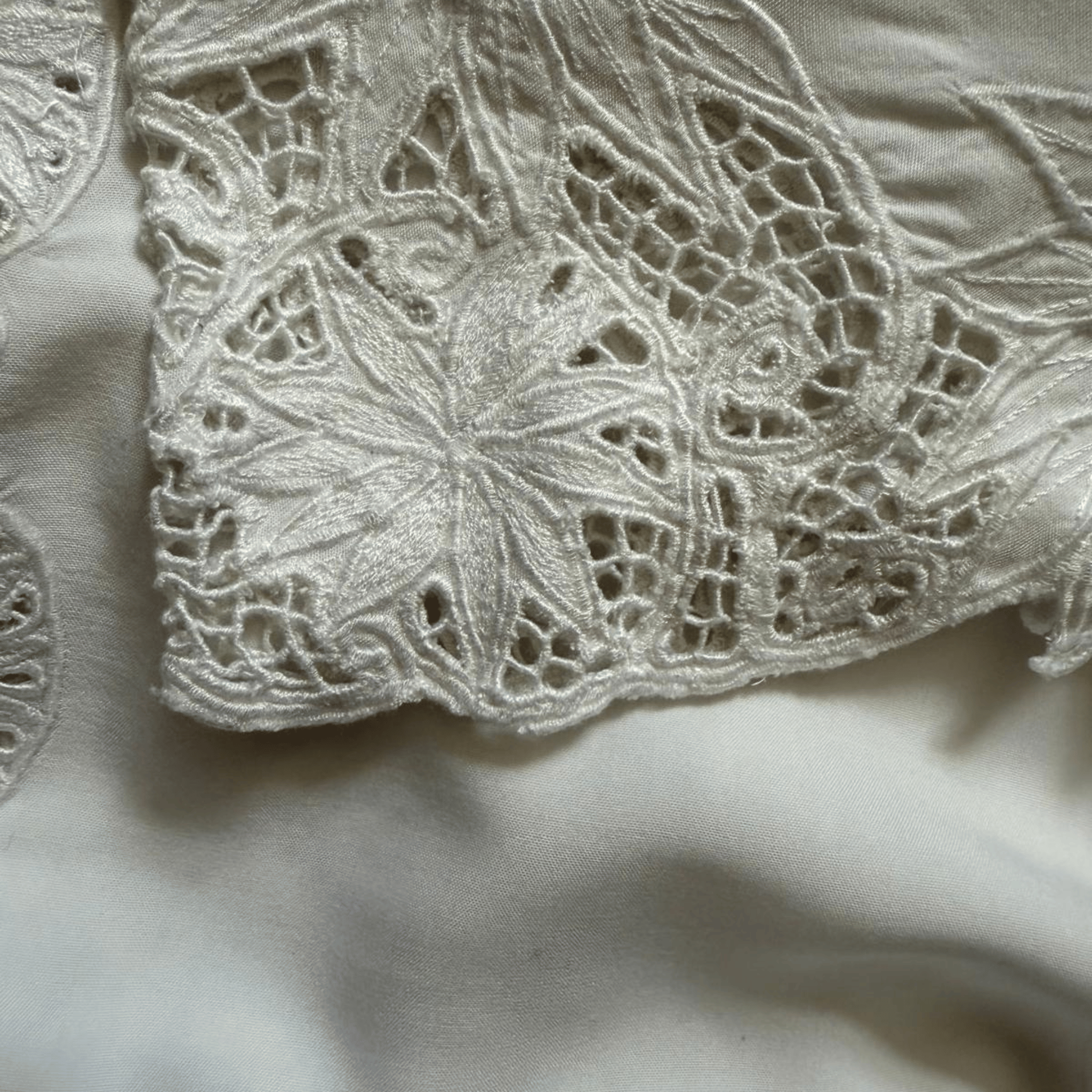 White blouse with openwork embroidery and lace - an elegant women's blouse with a decorative neckline