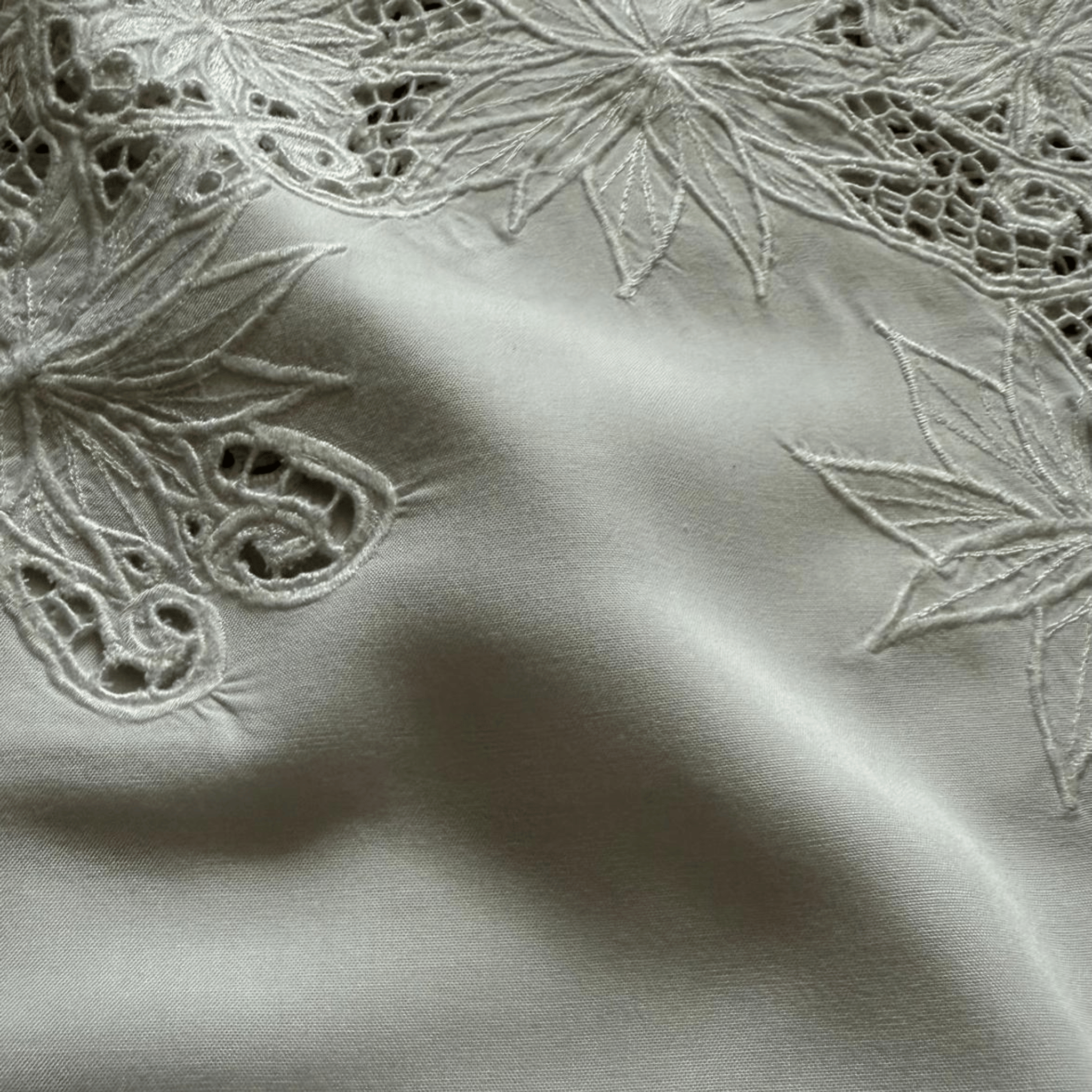 White blouse with openwork embroidery and lace - an elegant women's blouse with a decorative neckline