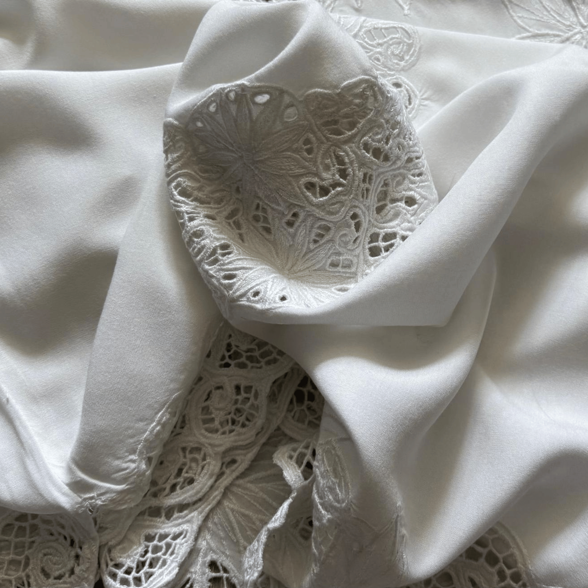 White blouse with openwork embroidery and lace - an elegant women's blouse with a decorative neckline