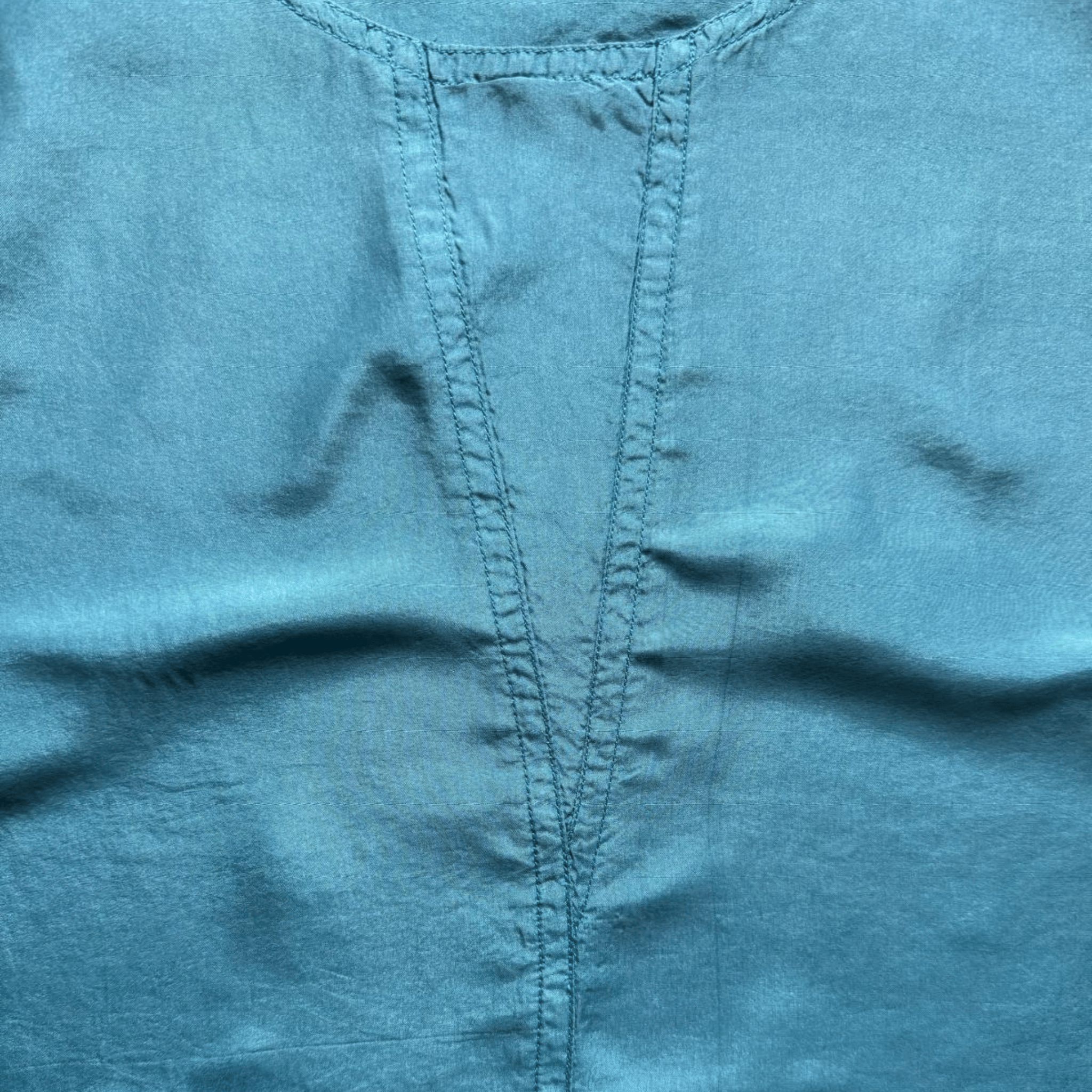 Sleeveless blue silk satin top with a scoop neckline